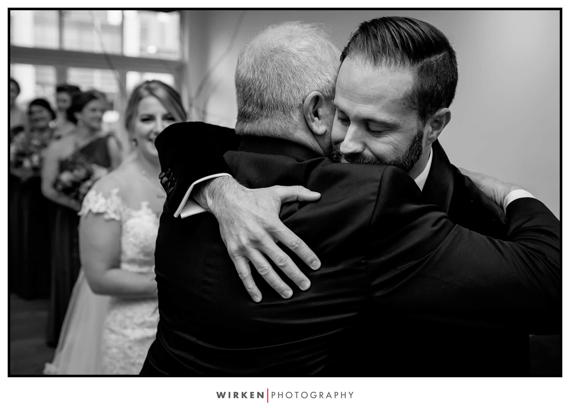 Ryan gives Leah's dad a hug after she walks down the aisle.