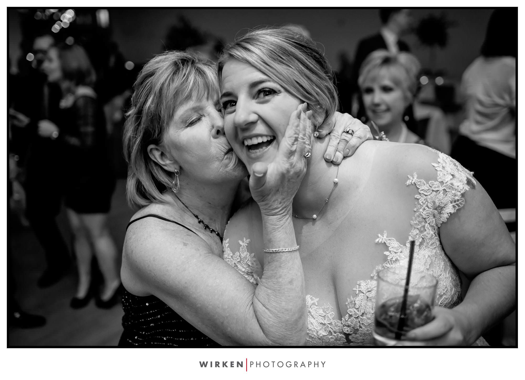 Leah gets a smooch from her mom at her wedding reception.